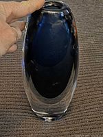 Front view of clear cased glass vase with deep blue interior