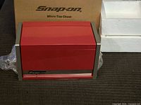 Front view of red Snap-on micro top chest with original box and styrofoam
