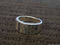 Ring profile showing abalone shell inlay panels and silver band