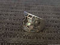 Front view showing floral cutouts and abalone inlay