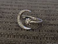 Top view of sterling ring showing crescent moon with stones and star