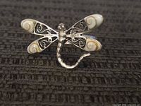 Top view of ring showing dragonfly shape, shell cabochons, filigree wings