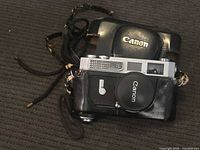 Canon Model 7 camera inside leather case with strap visible