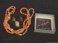 Necklace strands, two gold-tone earrings, info card box lid