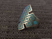 Front view of sterling silver geometric turquoise inlay ring