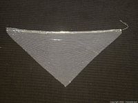 Full view of triangular silver-tone mesh bib necklace laid flat