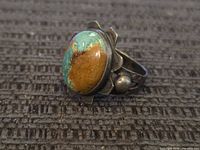 Side view showing turquoise cabochon, bezel, patina