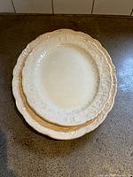 Top view of both stacked platters showing size difference and rim design