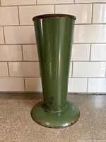 Front view of green enamel metal florist vase showing full shape and color