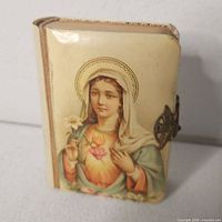 Front cover showing Virgin Mary image, celluloid surface and clasp