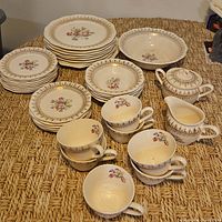 stacked dinner, dessert, saucers, cups, bowls, cream and sugar showing overall set