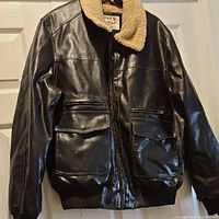 Full front view of the Levi's faux leather bomber jacket hanging