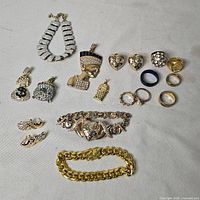 Full layout showing all bracelets, pendants, rings, earrings on white background