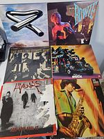 Six album covers laid out for identification: Tubular Bells, Diamond Dogs, The Rolling Stones Now!, 1966 rock compilation, Hyenas In The Desert, unidentified jazz sax LP