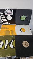 Six house and dance 12-inch vinyl records on display