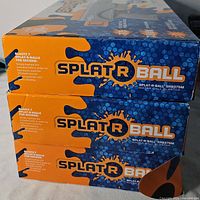 Stacked retail boxes showing Splat R Ball branding and model SRB375M