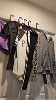 All five clothing items hanging on door