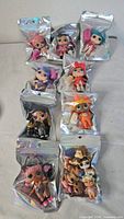 All ten holographic pouches with dolls and accessories