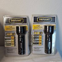 Two retail-sealed Defiant 51 LED flashlights with batteries