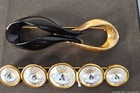 Front view showing both brooches, detailing design and stones