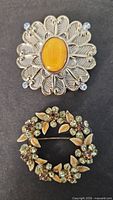 Front view of both brooches showing design details
