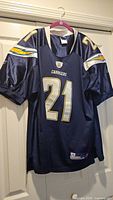 Full view of the navy blue Chargers #21 jersey hanging