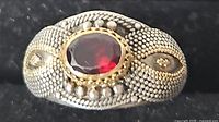 Front view of ring showing garnet and gold bezel