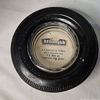 Top view of tire ashtray showing label and tread