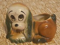 front view of ceramic sad eye dog planter