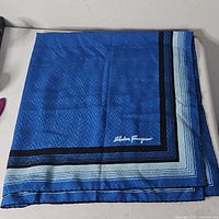 Full view folded blue Ferragamo silk scarf