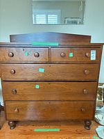 Full frontal view of antique wooden chest showing all drawers and overall condition