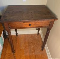 Front and side view of wooden nightstand in corner