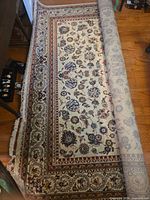 Rug partially unrolled showing full width and pattern