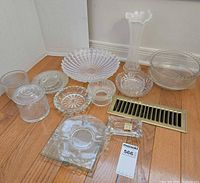 Group shot of all clear pressed glass pieces on floor