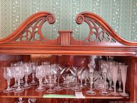 Shelf with assorted crystal stemware and small decorative pieces