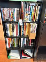 Full view of shelving with DVDs, books, magazines and binders