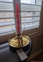 brass candle holder with glass shade and red candle