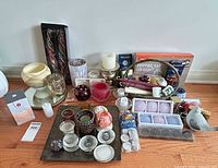 overall view of assorted candles and holders on floor