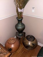 Vase on stand with both lidded jars visible