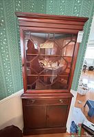 Full view of front showing glass door, drawer and lower cabinet