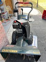 Front view showing Craftsman branding, chute, auger and control handles