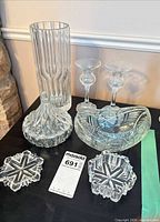 All seven cut glass pieces grouped on table
