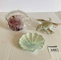 overview of three glass sea-themed ornaments