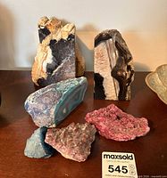 All six mineral pieces grouped on surface
