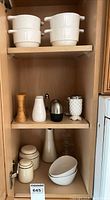 Cupboard overview showing bowls, shakers, canisters, bowls, vase, candlestick