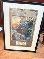 Full view of framed art showing winter scene print and calendar page