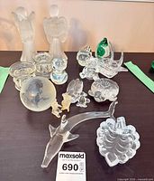 Full lot view showing all glass items including angels, swordfish, shell dish, paperweight, trinket dishes, small animals and green duck