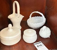 Five hobnail milk glass items arranged in cabinet