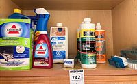 Upper shelf with various branded cleaners and pads