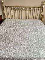 Brass headboard, mattress on frame